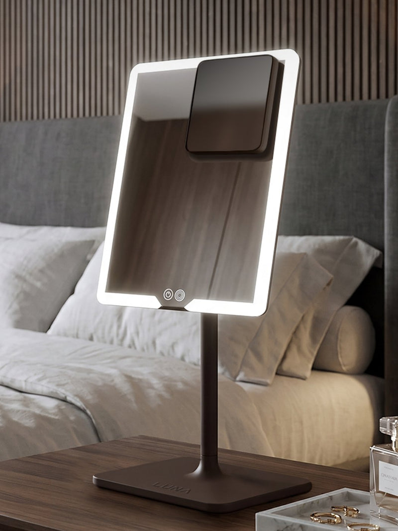ORBIT light up makeup mirror glowing on a bedside dressing table